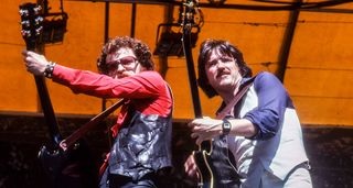 Eric Bloom and Buck Dharma rocking Oakland Stadium in 1978 with Blue Öyster Cult. Bloom is on the ride, wearing shades with a red shirt and leather waistcoat. Dharma on the right wears blue and white and plays a Les Paul