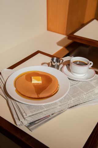 Coffee and pancakes on table
