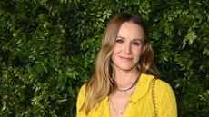 a headshot of kristen bell wearing yellow