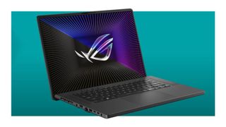 The Asus ROG Zephyrus G16 2023 on a teal deals background.