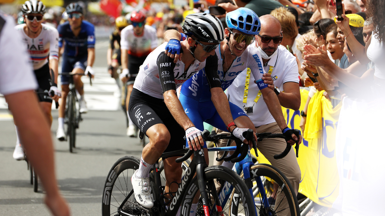 Adam and Simon Yates celebrate together after completing stage one of the Tour de France 2023