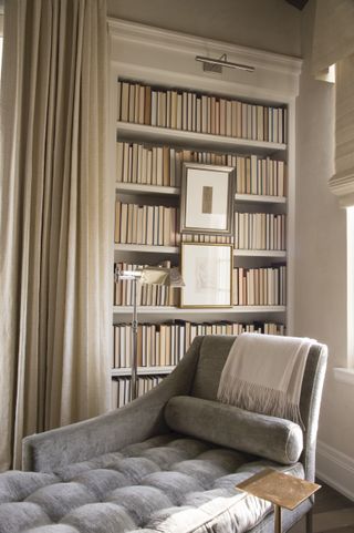 Bookshelves and chaise in neutrally decorated corner