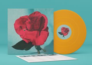 An image of an orange vinyl record and the Up On Gravity Hill album art
