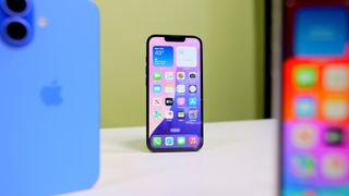 iPhone 16e on table with iPhone 16 and iPhone SE3