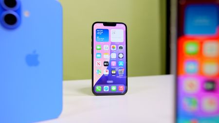 iPhone 16e on table with iPhone 16 and iPhone SE3