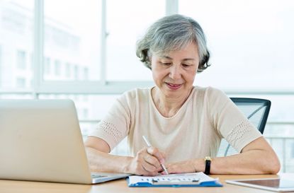 Senior woman using laptop at home.