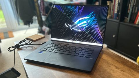 Asus ROG Zephyrus M16 gaming laptop sitting on wooden table