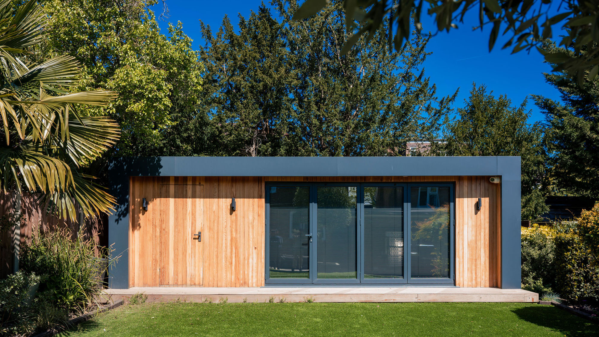 modern garden room with bifold doors and timber cladding