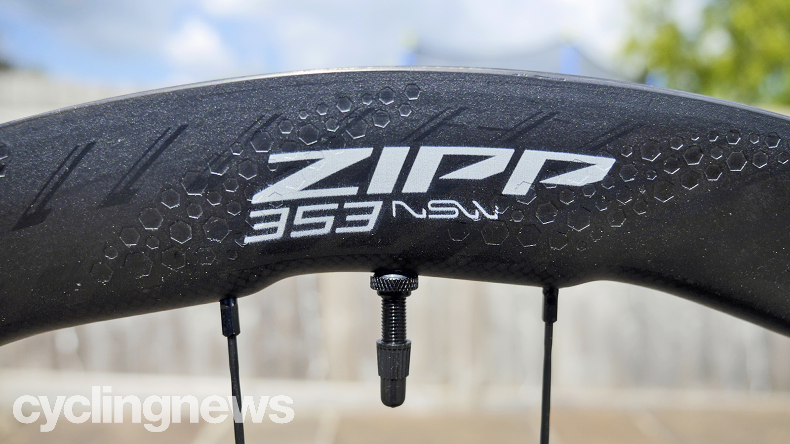 Closeup of Zipp 353 NSW wheel, showing sawtooth rim and tubeless valve