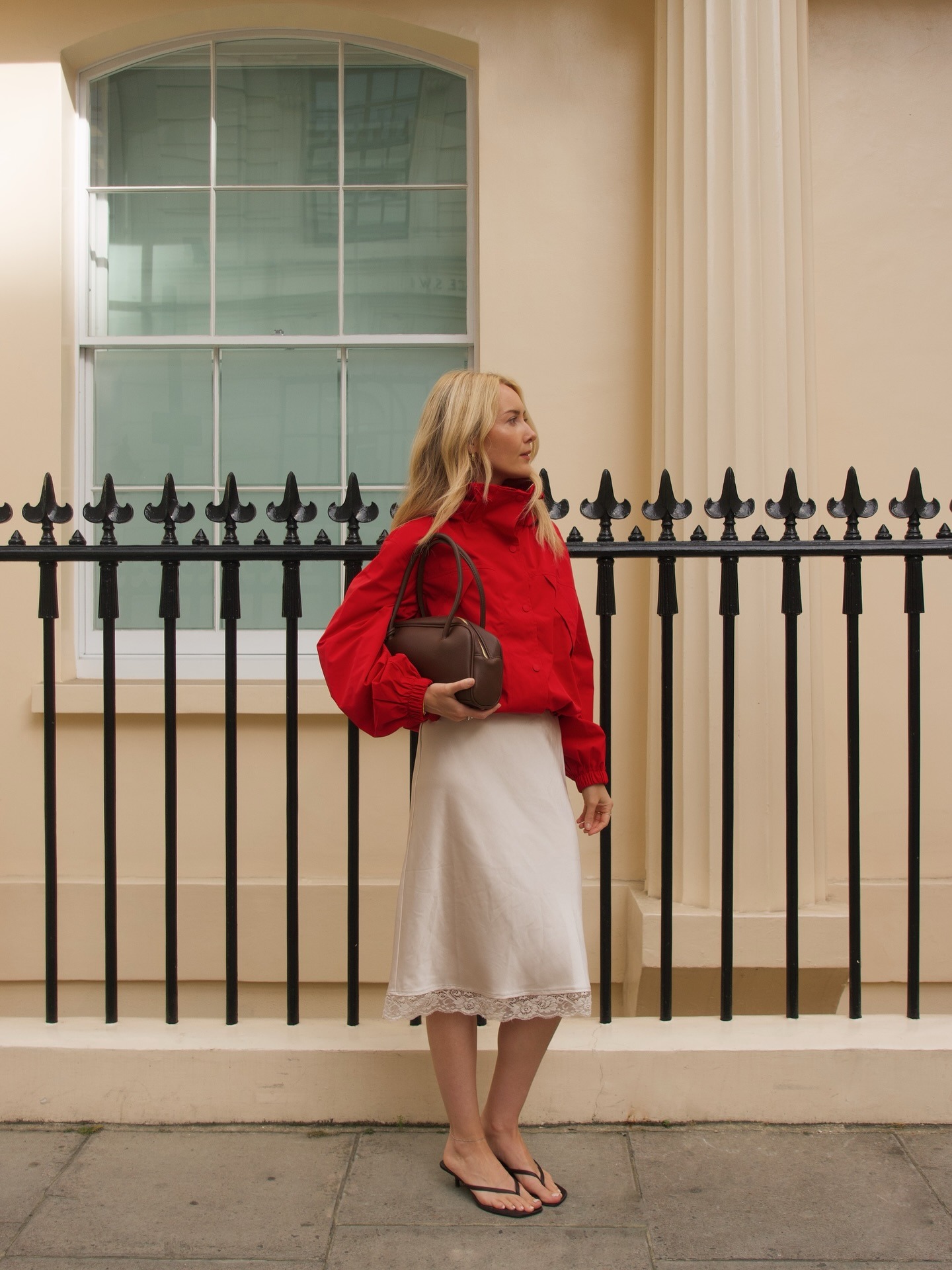Chloe Kath Butler offers her influencer autumn wish list. She wears a red funnel neck jacket, satin lace skirt and thong flip flops.