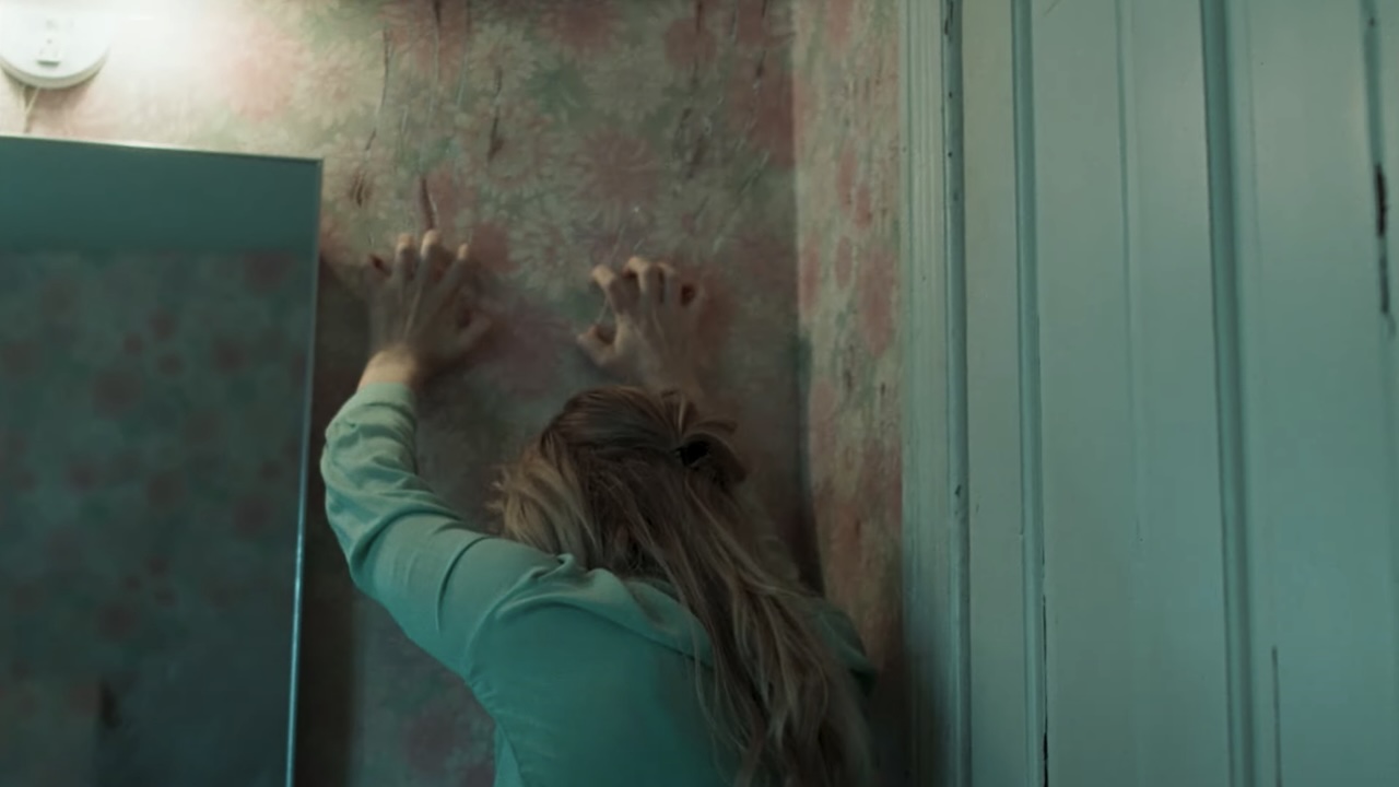 Grace scratching nails down wallpaper in Die, My Love