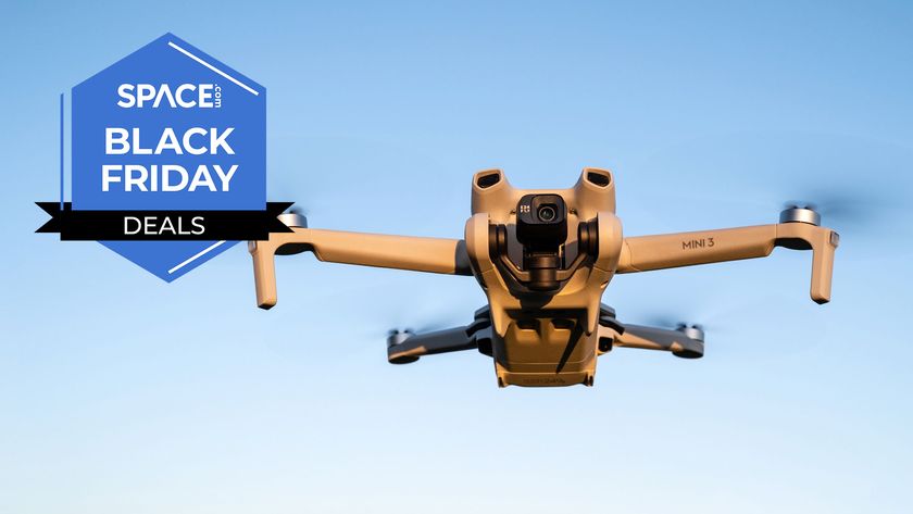 A DJI Mini 3 drone in the sky, next to a Space Black Friday deals badge. 