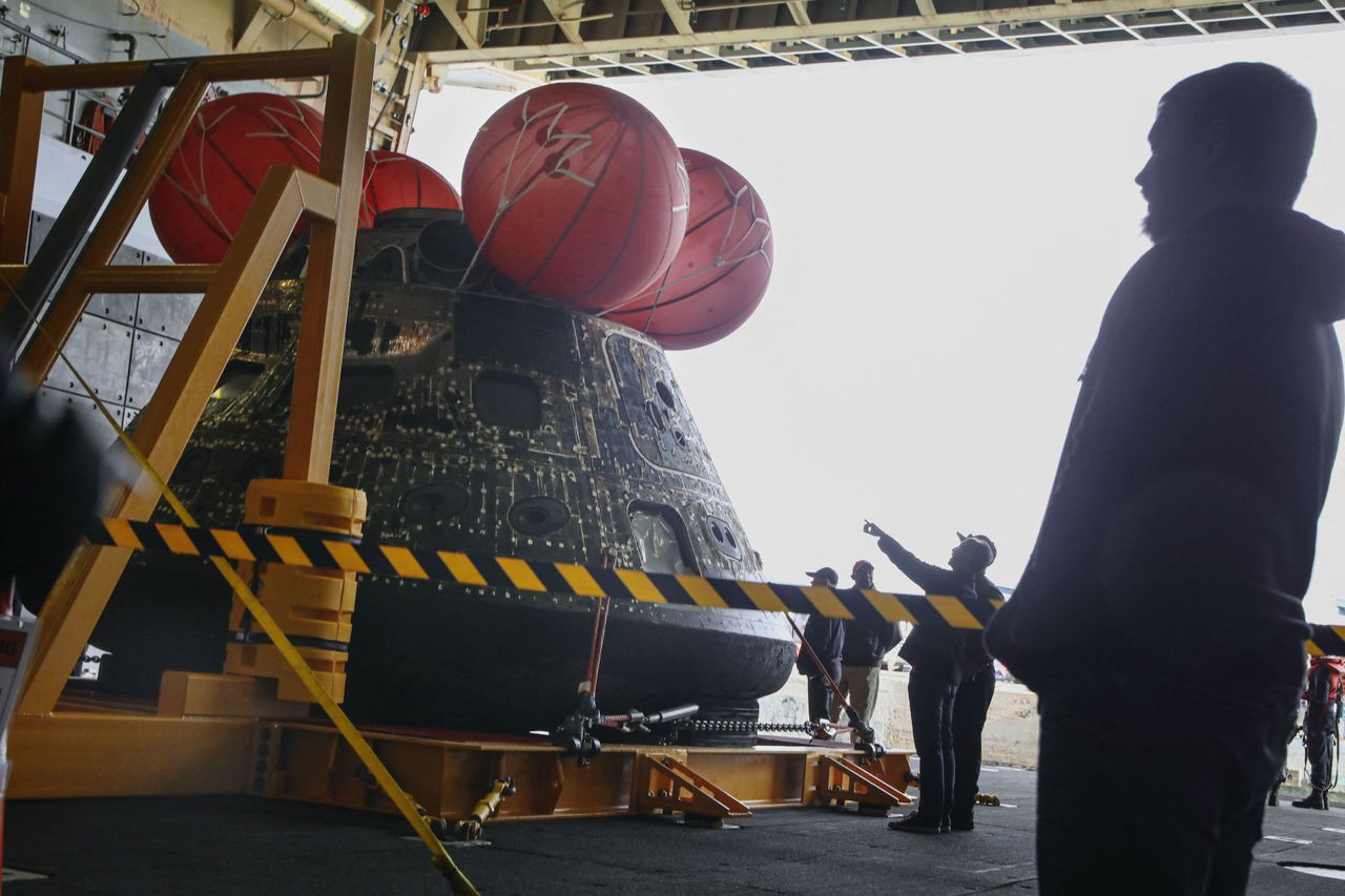 Pictures of the Orion spacecraft being treated after arriving in port in San Diego on Dec. 13, 2022.