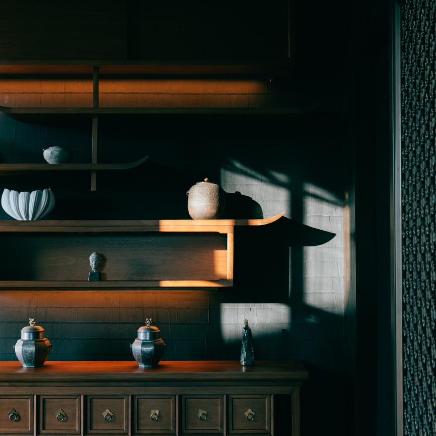 chic hotel lobby interiors with dark shelves and pottery