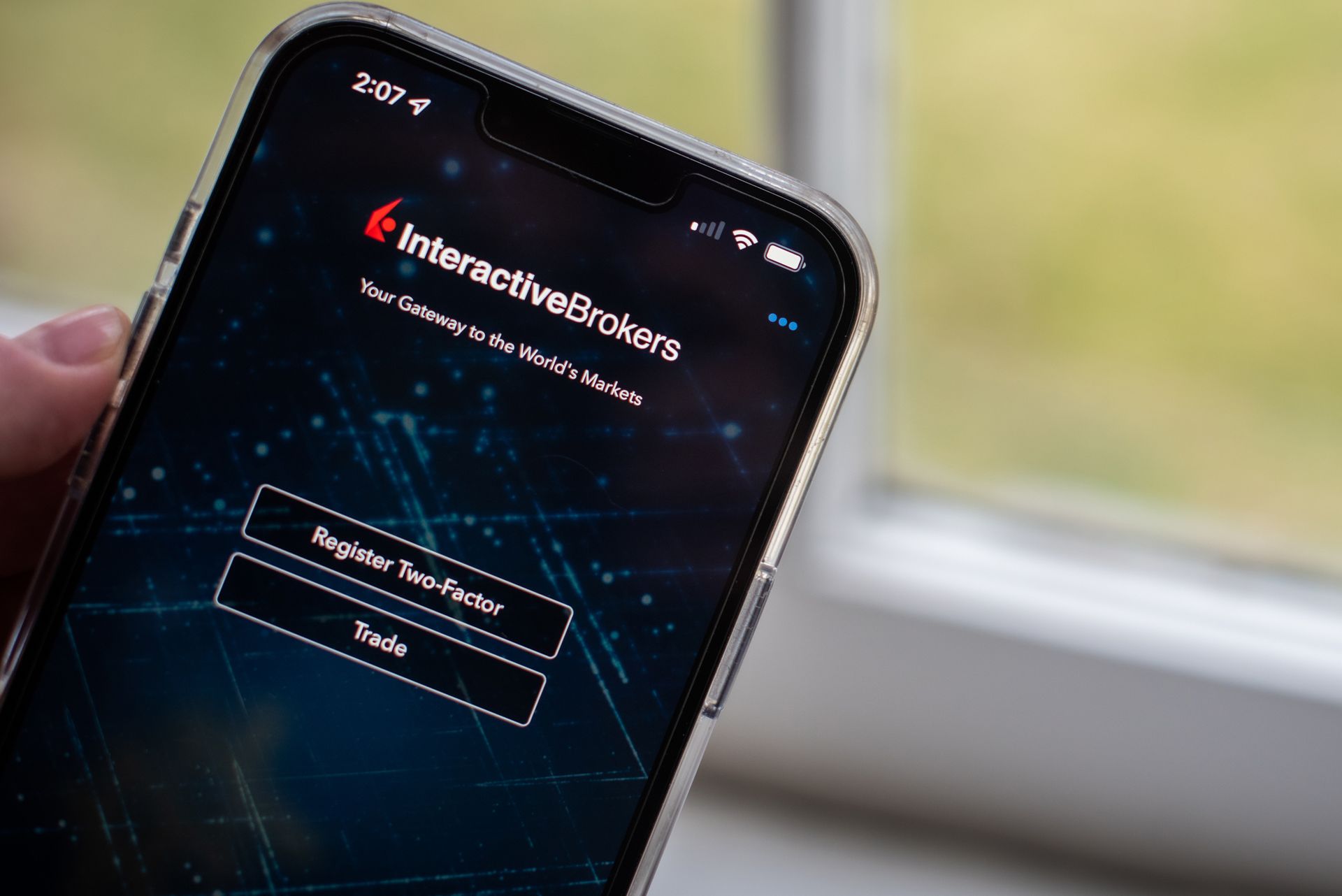 person using InteractiveBrokers trading platform on smartphone