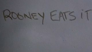 Graffiti on a bus that says "Rooney Eats It" in Ferris Bueller's Day Off