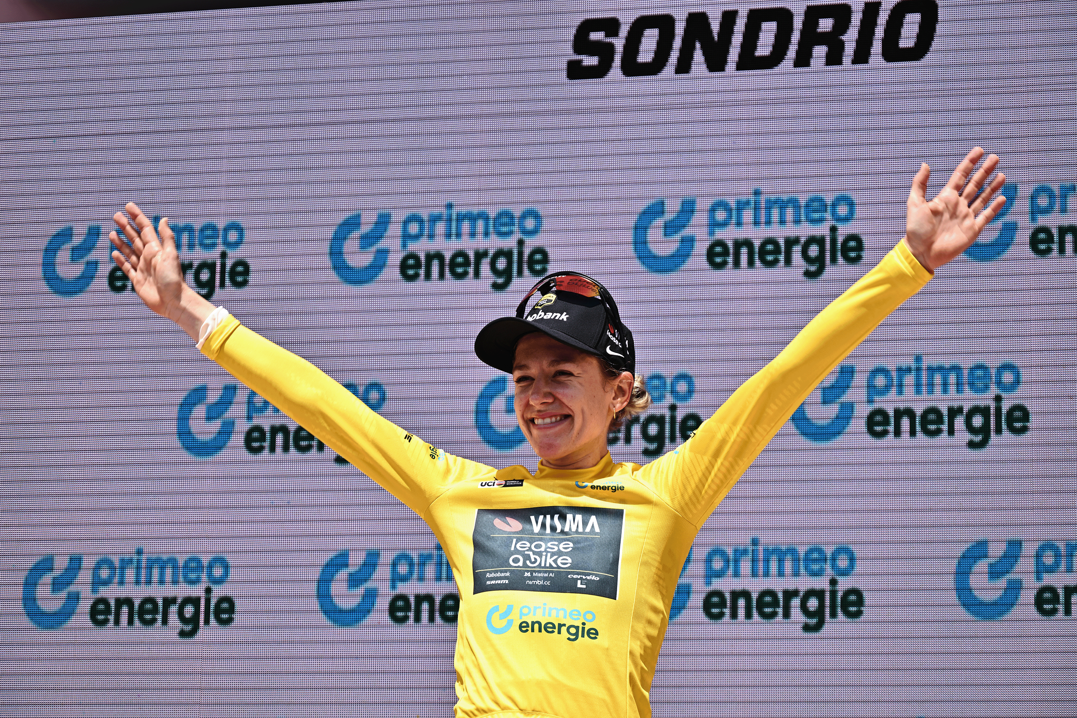 Dutch rider Femke De Vries of team Visma-Lease a Bike poses on the podium after winning the first stage of the Women's Tour of Switzerland (Tour de Suisse) cycling race, in Sondrio, Italy, on June 17, 2026. Femke De Vries of team Visma-Lease a Bike won the stage ahead of British Ailish Lauren Dickson (L) and French Cedrine Kerboal. (Photo by Marco BERTORELLO / AFP via Getty Images)