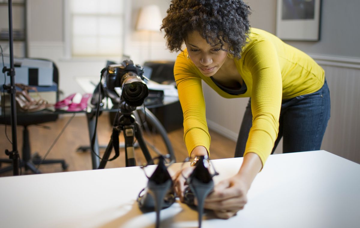 Best camera for product photography: woman photography a pair of shoes with DLR