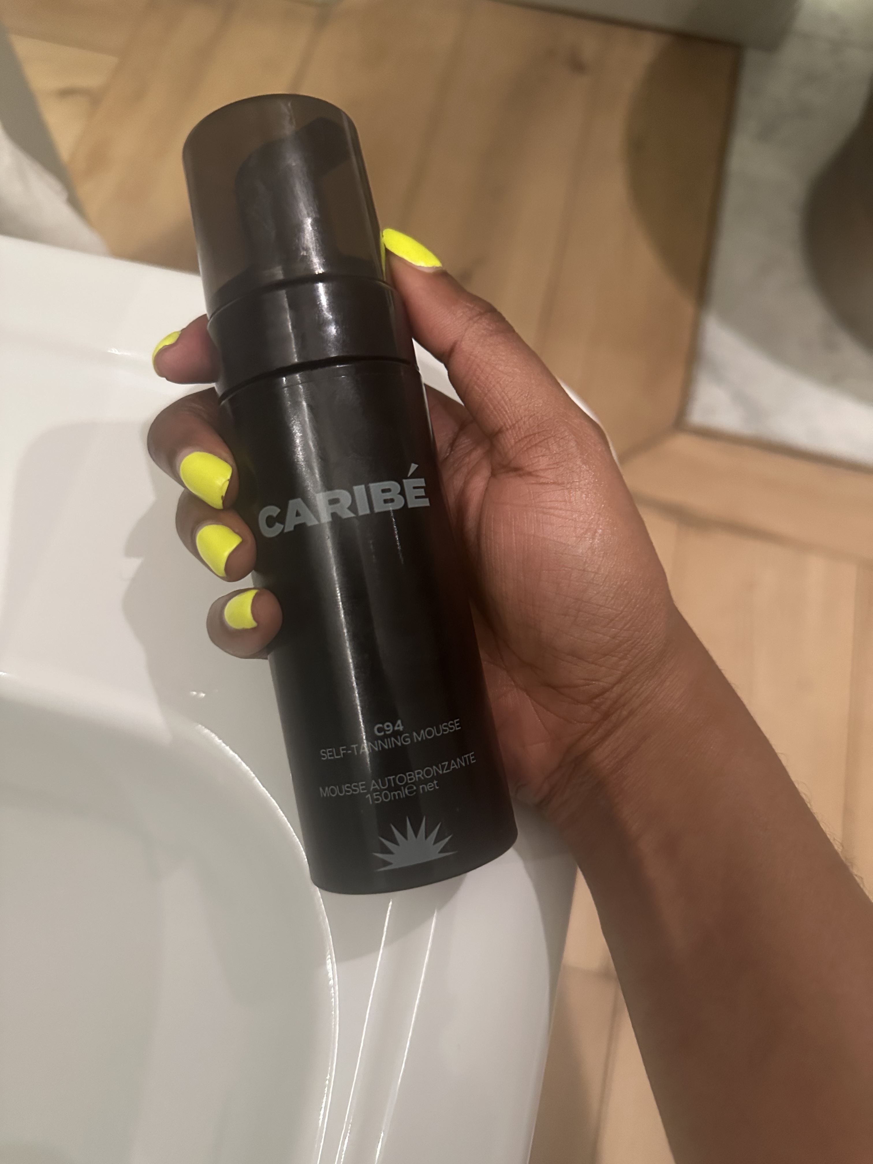 Felicia holding a bottle of Caribe tan