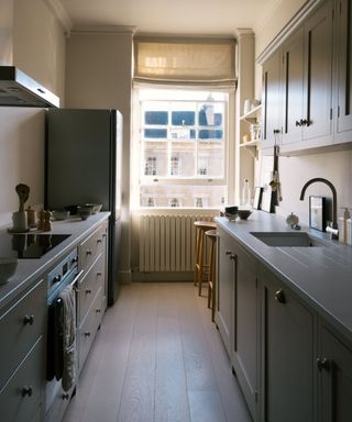 A galley kitchen with staggered countertops to create a small breakfast bar