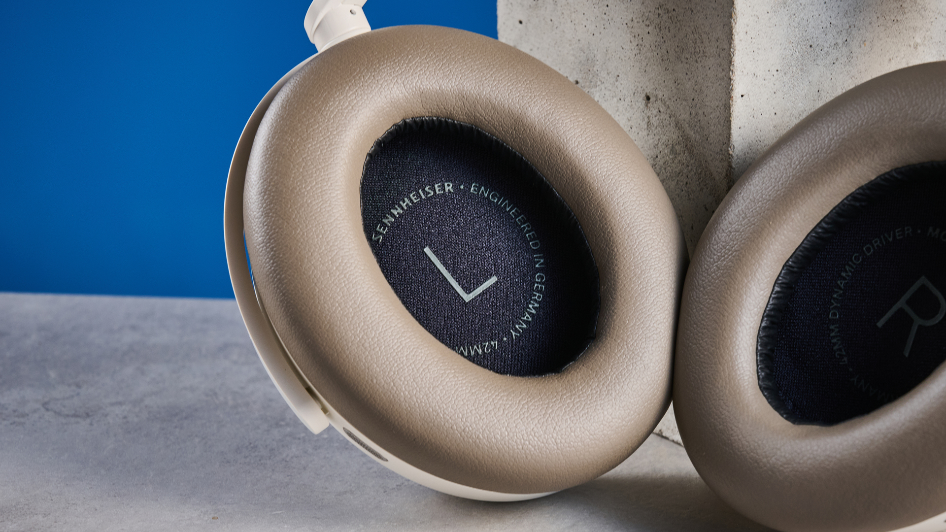 the sennheiser momentum 5 in white photographed against the blue tom's guide background