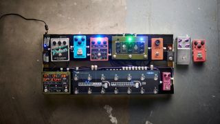 Pedalboard with extra pedals on a concrete floor