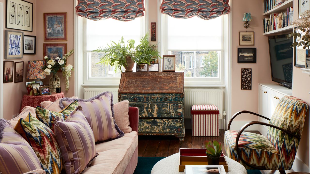 colorful eclectic living room with pink walls and pink sofa, bentwood chair with zig zag pattern and shaped ottoman