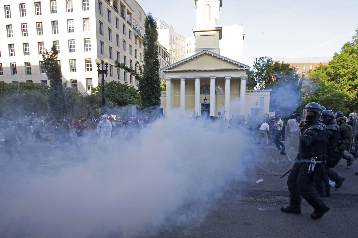 Police officers wearing riot gear push back demonstrators shooting tear gas next to St. John&#039;s Episcopal Church outside of the White House, June 1, 2020 in Washington D.C., during a protest over the death of George Floyd.