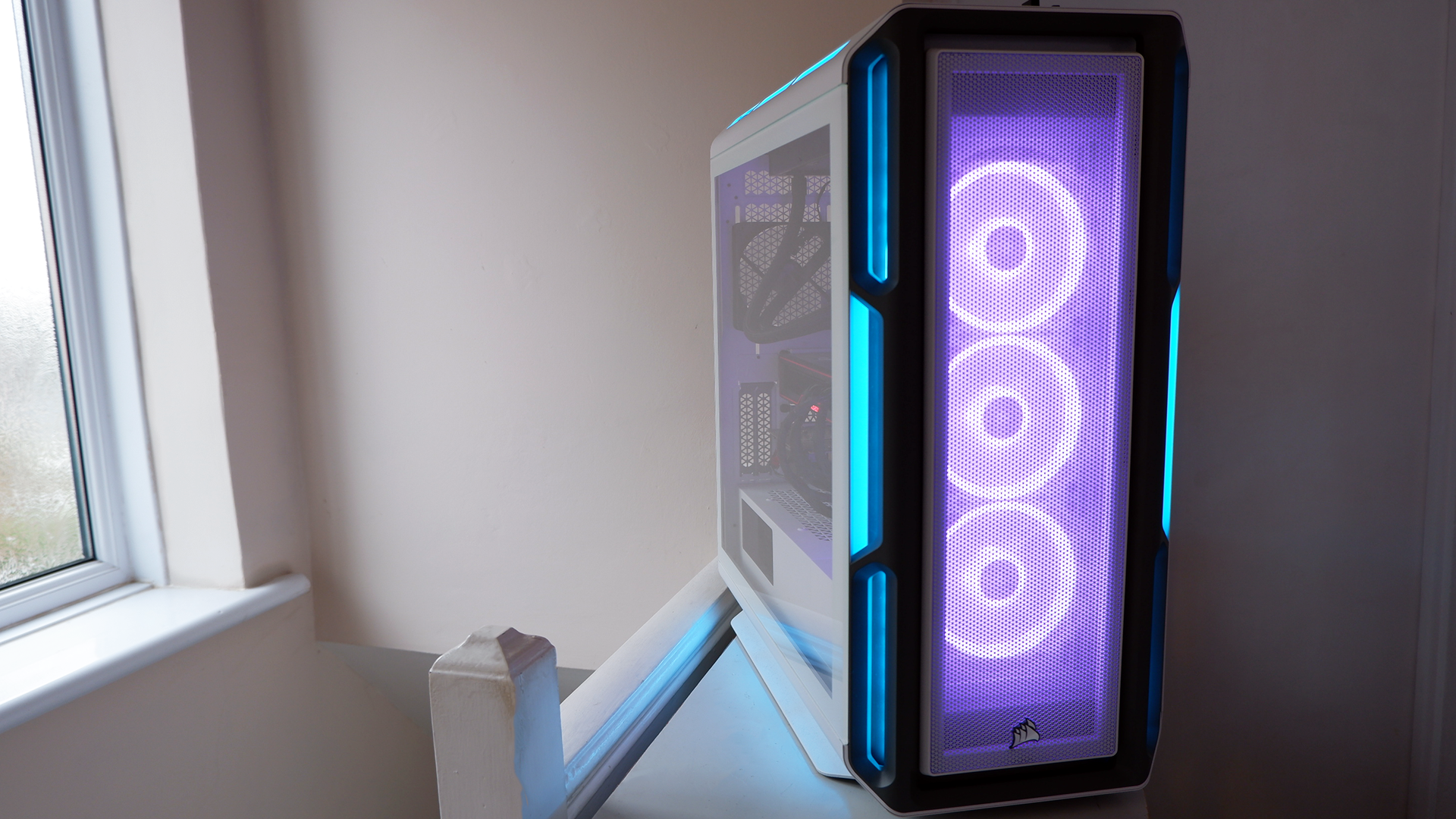 Corsair iCUE 5000T RGB mid-tower PC case with RGB lighting enabled in blue and pink