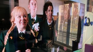 A TV screen showing the show Derry Girls, where part of the image is obscured by reflections from a window