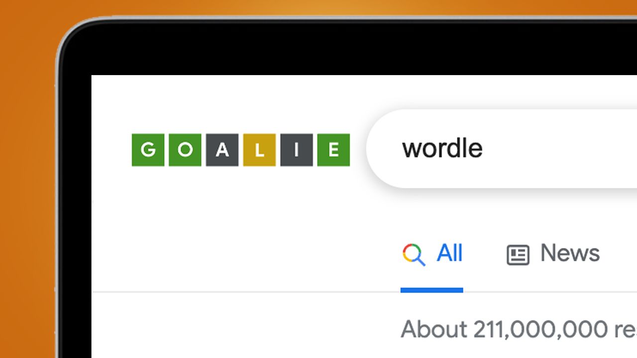 A laptop screen on an orange background showing a Google easter egg for Wordle