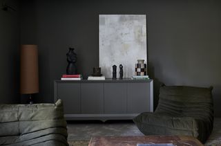 A charcoal colored living room with Togo sofa