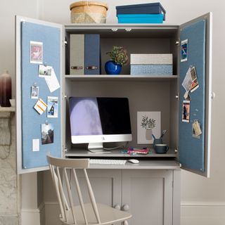Grey cupboard with computer inside