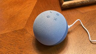 En smart-høyttaler av typen Amazon Echo Dot (2020) på en bordplate.