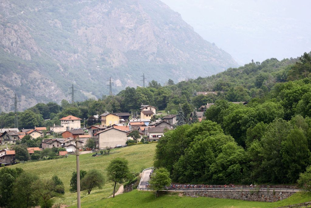 COGNE ITALY MAY 22 A general view of the Peloton passing through Quart 533m during the 105th Giro dItalia 2022 Stage 15 a 177km stage from Rivarolo Canavese to Cogne 1622m Giro WorldTour on May 22 2022 in Cogne Italy Photo by Michael SteeleGetty Images