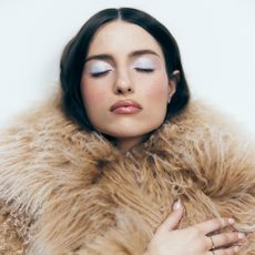 TikTok start Madeline Argy poses in furry brown coat by Givenchy