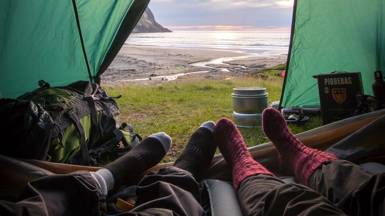 down vs synthetic sleeping bag: two people in sleeping bags in a tent