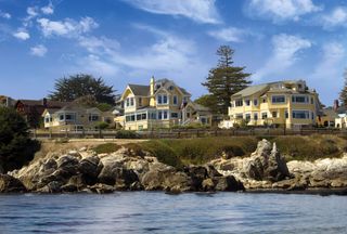 The exterior view of the yellow Seven Gables Inn in Pacific Grove, California