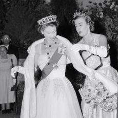 Lady Pamela Hicks helping Queen Elizabeth with her shawl