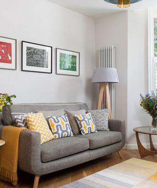 small living room with grey sofa and yellow accessories
