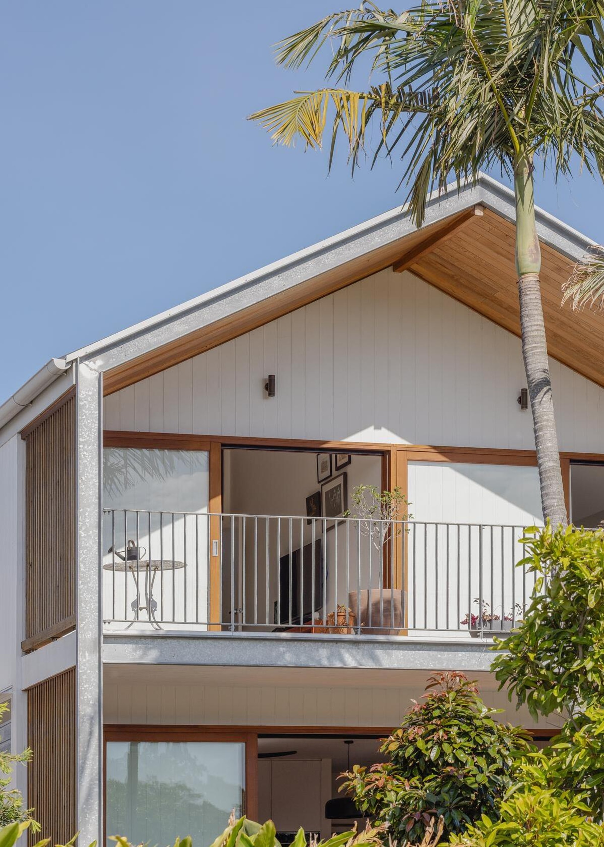 balcony with pitched roof shade and an open door leading to the living room