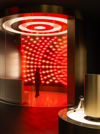 Inside Ya-man Tokyo store with futuristic red lighting resembling Star Trek's transporter room