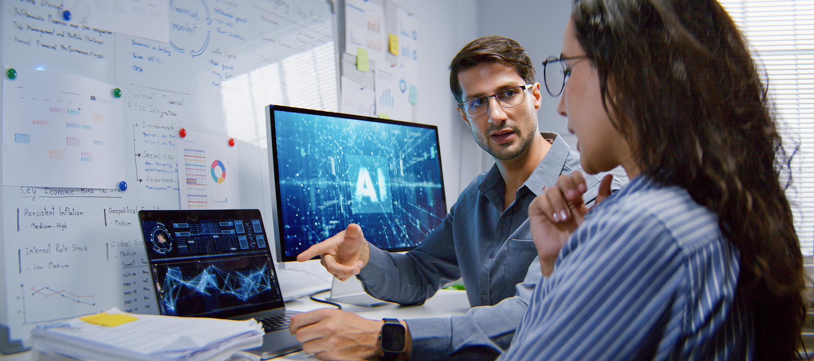 Male and female programmer engineer use AI software on laptop computer, meeting discussion at home office.