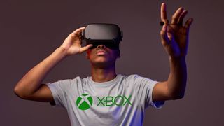 Man playing VR wearing a grey Xbox T-shirt