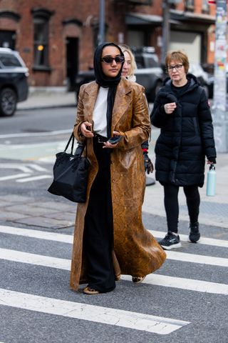 A woman walks down the street at fashion week