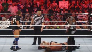 The Miz and R-Truth standing over Triple H and CM Punk at Night of Champions