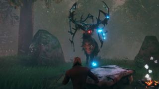 Valheim boss Eikthyr: A large black deer with glowing red eyes and many pointed horns stands before a player in a dark forest.