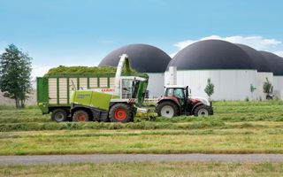 Green gas mIll with tractor harvesting grass