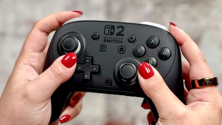 A person holding the Nintendo Switch 2 Pro Controller in hand