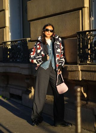 Gabriella Bertugo in a patterned puffa jacket, denim shirt and black trousers